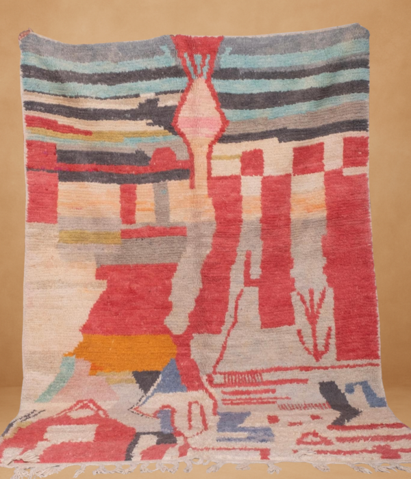 Boujad rug featuring an abstract, painterly composition in warm tones of red, coral, peach, grey, mustard, and hints of blue and green. Handwoven in wool, the rug has a textured, artistic aesthetic with freeform shapes and soft fringe along the bottom, displayed against a neutral background.