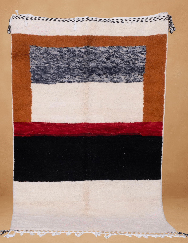 Contemporary Boujad rug featuring bold horizontal blocks of color in burnt orange, navy blue, deep red, black, and cream. The minimalist, modernist design is handwoven in wool, with black and white braided fringes and displayed vertically against a neutral background.