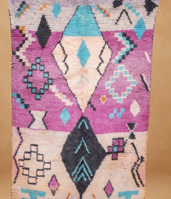 Vibrant Boujad rug with bold purple, teal, and black geometric patterns.