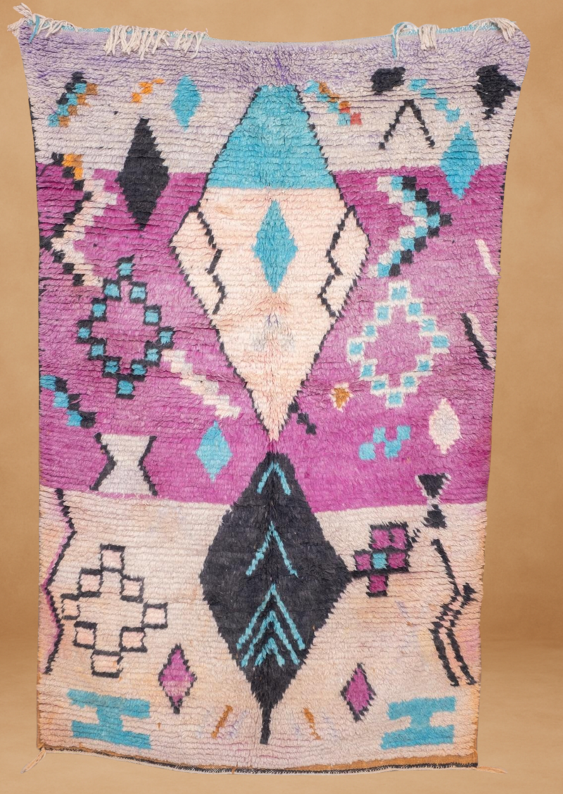 Vibrant Boujad rug with bold purple, teal, and black geometric patterns.