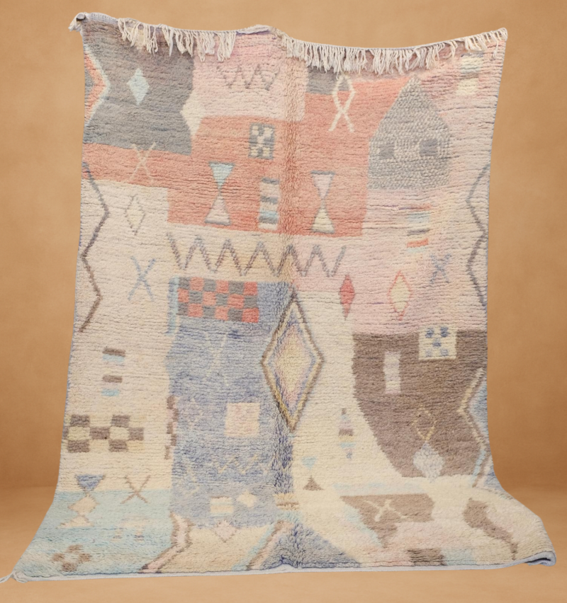 Enchanting Boujad rug showcasing pastel tones with geometric motifs. A soft, handwoven masterpiece to add charm and warmth to your space.