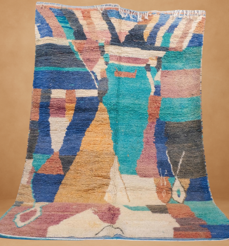 Bold Boujad rug in vibrant teal, pink, and blue. Handwoven masterpiece with abstract patterns, adding color and Moroccan charm to any space.