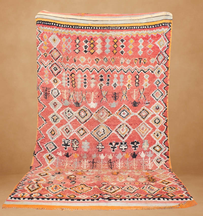 Traditional Beni Mguild rug with rich coral tones and intricate geometric patterns.