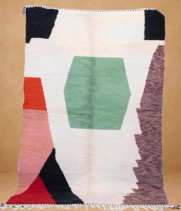 Modern Boujad rug with bold geometric shapes in green, red, black, and cream tones.