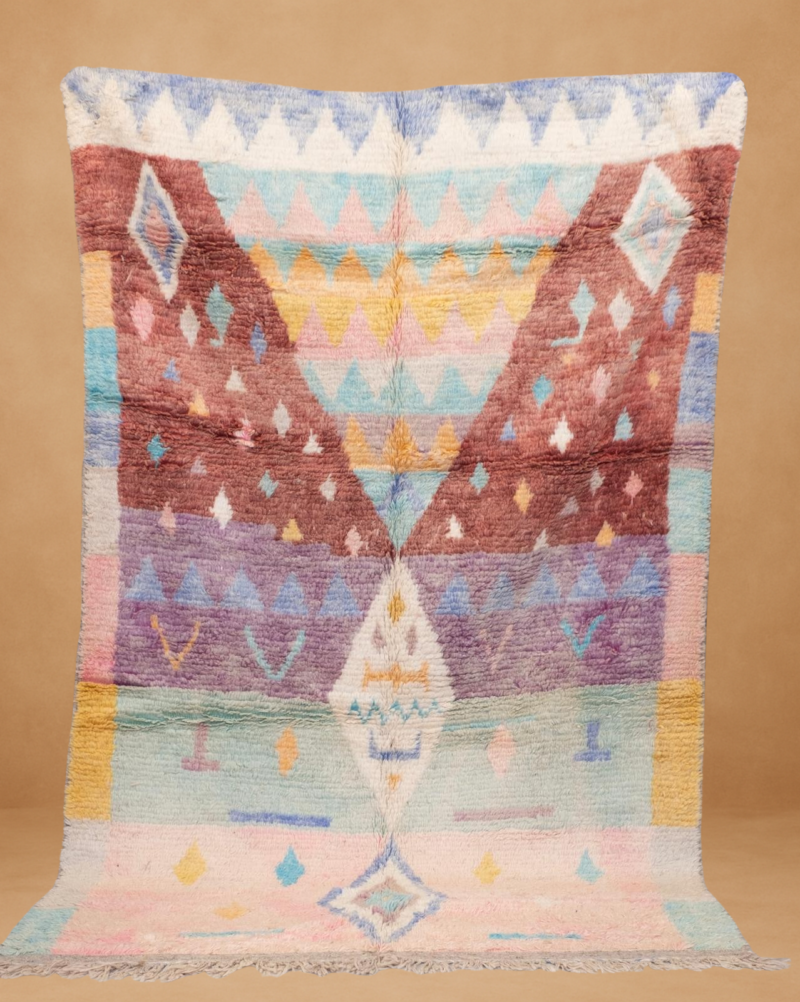 Delightful Boujad rug featuring pastel hues and geometric patterns. A handwoven treasure that adds softness and elegance to any interior.