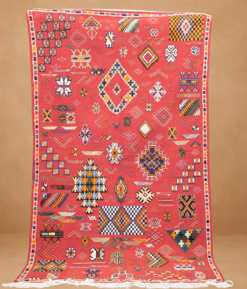 Vivid Kilim rug in ruby red, featuring intricate tribal symbols and geometric shapes. Lightweight and flatwoven.