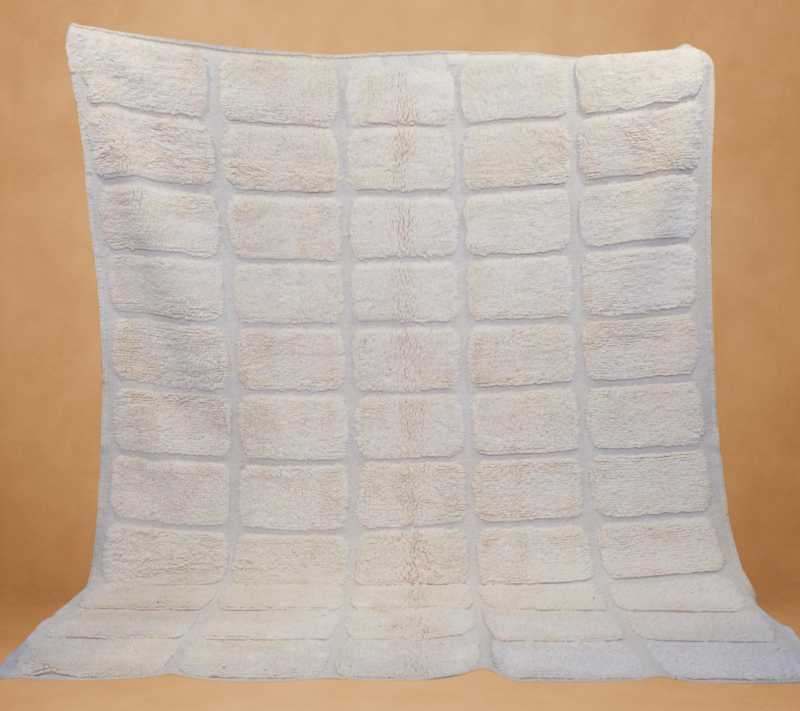 A cozy blend of creamy rectangles on a plush surface, offering a structured yet comforting addition to your decor.