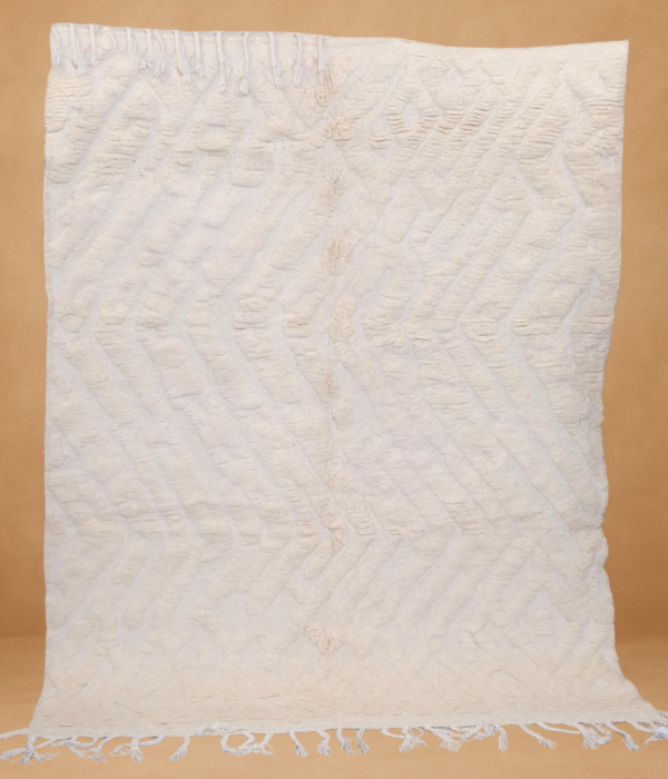 Textured Boujad rug with soft cream tones and subtle geometric patterns.