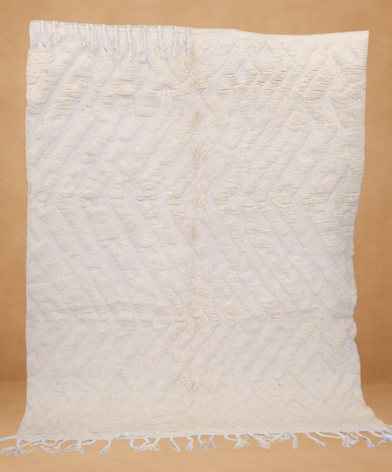 Textured Boujad rug with soft cream tones and subtle geometric patterns.